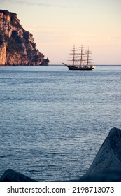 Classic Sailboat Anchored In The Bay At Sunrise