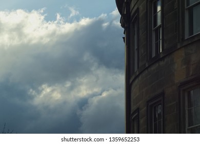 A Classic Sandstone Edinburgh Tenement Facade Building Against A Stormy Sky