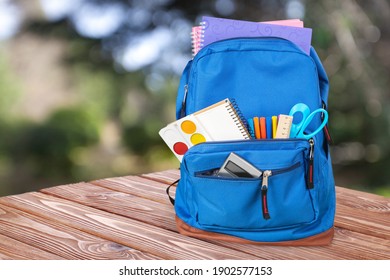 Classic School Backpack With Colorful School Supplies And Books On Desk.