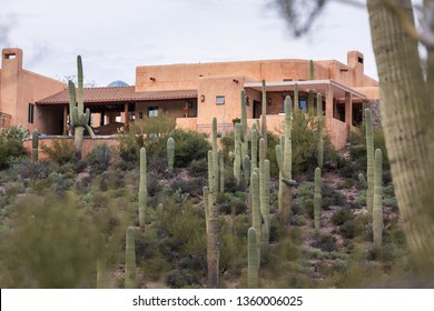 Classic Southwestern Country House Surrounded By Saguaro Cactus In Desert