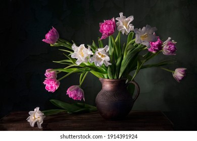 Classic still life with beautiful white and pink tulip flowers bouquet in vintage clay jar. Art photography. - Powered by Shutterstock