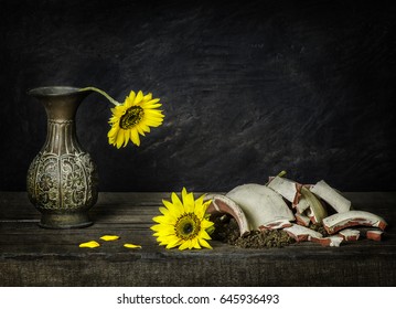 Classic still life with sunflowers placed on rustic wooden background.Brokenness concept