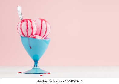 Classic Strawberry Ice Cream Balls In Blue Bowl With Red Sweet Sauce, Spoon On White Wooden Table, Soft Light Pastel Pink Background.