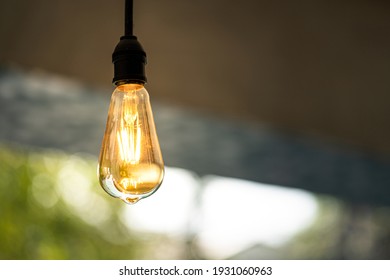 A Classic Style Ceiling Light Bulb Which Is Glowing In Orange Warm Lighting Shade. Interior Object For Room Decoration. Close-up And Selective Focus.