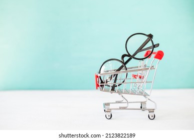 Classic Style Glasses In Shopping Cart With Space On Blue Background, Eye Wear Fashion, Buy New Glasses