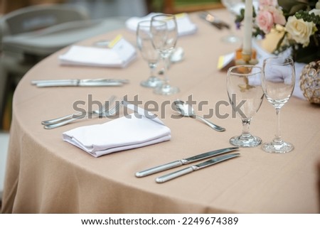 Classic table settings for fine dining with cutlery, glassware, flowers and candles. Props for eweddings, vents, birthdays, gala banquet.