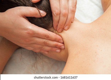 Classic, therapeutic massage on the head and neck with the hands of a masseur - Powered by Shutterstock