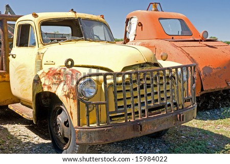 Classic truck with rust, broken windshield, and grille guard