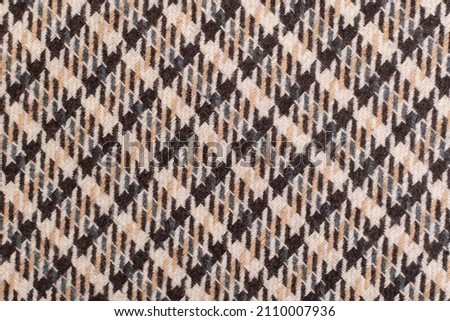 Classic tweed, Wool Background Texture. Coat close-up. Expensive men's suit fabric. Glenurquhart check is made of woolen fabric with a woven twill design of small and large checks. Houndstooth seamles