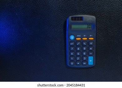 Classic Typical Black Calculator. Economy And Accounting Symbol. Mathematics And Accurate Calculations. Maintaining A Family Budget. Background With Copy Space For Text Or Lettering