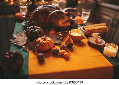 Classic USA Thanksgiving Day Dinner With Holiday Autumn Decor And Candles. Family Dining Room Table Set With Delicious Golden Roasted Turkey On Platter Garnished Rosemary And Fresh Small Pumpkins