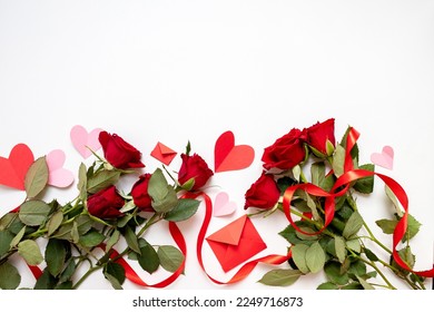 
classic valentine's day background with hearts,envelopes, roses on white background. copy space. top view