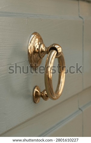Classic Victorian solid brass door knocker with a polished finish ideal for real estate home design and exterior architectural decoration concepts