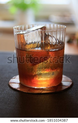 Classic Vieux Carre cocktail with Cognac, Rye Whiskey, herbal liqueur and bitters in an Old Fashioned glass with clear ice cubes [[stock_photo]] © 