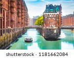 Classic view of famous Hamburg Speicherstadt warehouse district with sightseeing tour boat on a sunny day in summer, Hamburg, Germany
