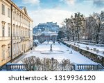 Classic view of famous Mirabell Gardens in the historic city of Salzburg with Hohensalzburg Fortress in golden evening light on a beautiful sunny day with blue sky in winter, Salzburger Land, Austria