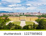 Classic view of famous Schonbrunn Palace with scenic Great Parterre garden on a beautiful sunny day with blue sky and clouds in summer, Vienna, Austria