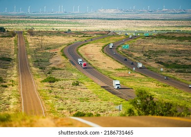 Classic View Of Highway Road Running Through The Barren Scenery Of The American Southwest With Extreme Heat Haze. Hot Sunny Day With Blue Sky In Summer.