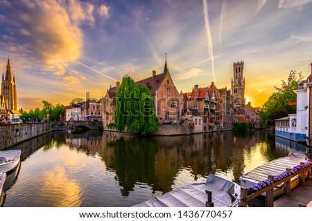 Classic view of the historic city center of Bruges (Brugge), West Flanders province, Belgium. Sunset cityscape of Bruges. Canals of Brugge