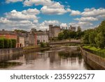 Classic view of Kilkenny castle from the river Nore with cloudy blue sky