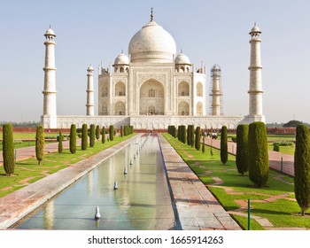 Classic view of the Taj Mahal, in the bright morning light before the crowds immerse the scene. - Shutterstock ID 1665914263