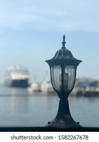 A Classic And Vintage Bridge Lamp With The Manila Bay, Ship And Boats In The Background