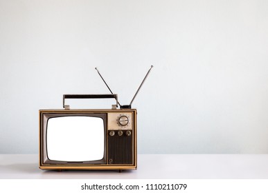 Classic, vintage old tv on table and cut out screen with clipping path isolated on white wall background, retro television style