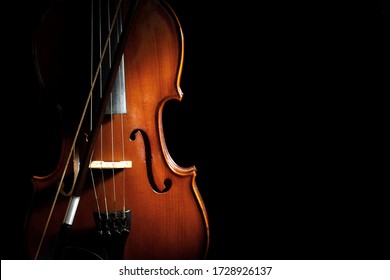 Classic violin and bow on black background. Space for text