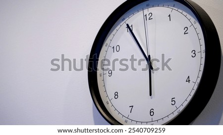 A classic wall clock displays the current time, emphasizing the importance of time management in daily life. The clock ticks rhythmically, serving as a reminder to value each moment.