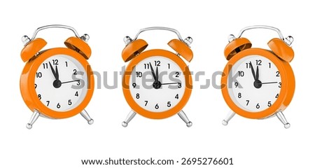 classic watch, pointer clock, Orange color alarm watch on isolated white background close up
