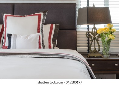 Classic White Bed With Pillows And Classic Lamp Style On Table Side At Home