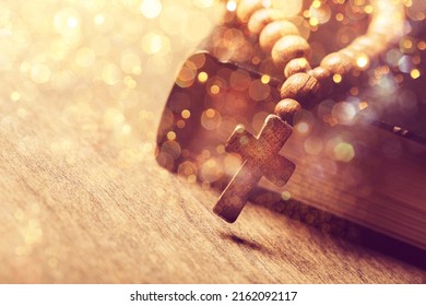 Classic Wooden Christian Cross Necklace Next To Holy Bible