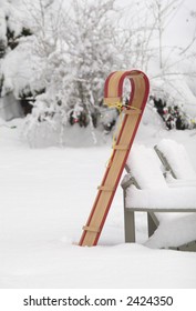 Classic Wooden Toboggan Upright In Snowy Yard