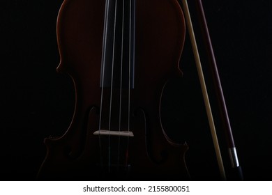Classic wooden violin and bow on black background. Vintage violin. Perfect for a wallpaper