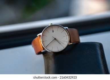 Classic wrist watch with white dial and classic brown wrist band on leather - Shutterstock ID 2160432923