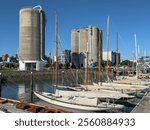 Classic yachts at Heritage Landing, Wynyard Quarter, Auckland, New Zealand, and Silo Park, old cement silos that have been repurposed as exhibition and movie venues.