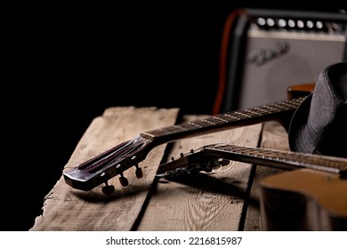 A Classical And An Acoustic Guitar, A Fedora On The Guitar. Guitar Amp In The Back. Stage Preparation.