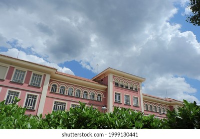 Classical Building Of An Old Public School Downtown Madrid, Spain. Voluminous Cloudscape