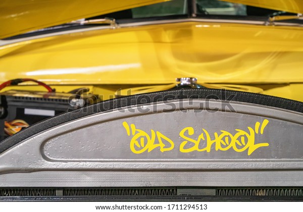 Classical car engine that writes old school with\
graffiti fonts.