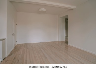 Classical empty room interior. The rooms have wooden floors and gray walls ,decorate with white moulding,there are white window looking out to the nature view.