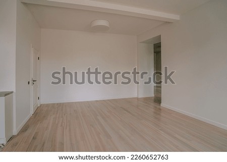 Classical empty room interior. The rooms have wooden floors and gray walls ,decorate with white moulding,there are white window looking out to the nature view.