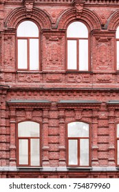 classical facade of an old building of red brick