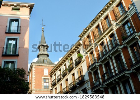 Classical facades downtown Madrid, Spain. Elegant buildings backlit by sun in the old city street