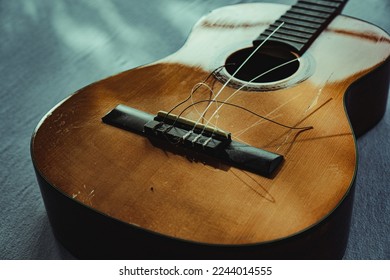 Classical guitar with broken strings 
