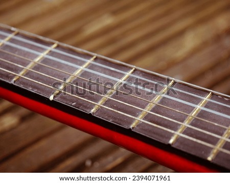 Classical guitar strings and frets medium shot selective focus