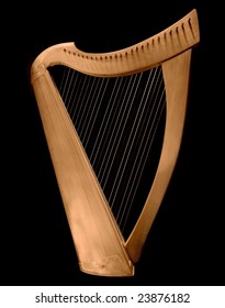 Classical Irish wooden harp on black background.