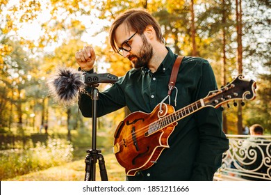 Classical Musician With A Mandolin Recording Outdoors