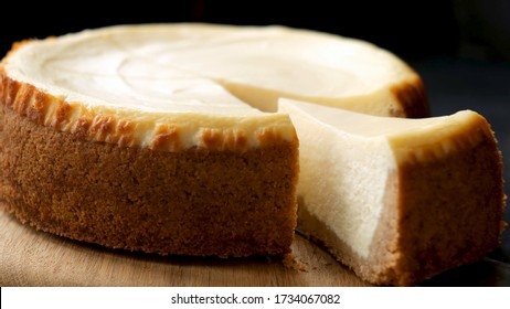 Classical New York Cheesecake With Slice Cut Out. Closeup View