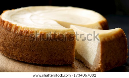 Classical New York Cheesecake With Slice Cut Out. Closeup View