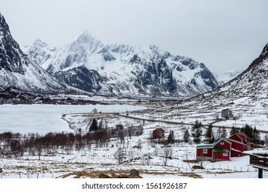 Classical Norway in winter: mountains with colorful houses and roads on a sunny winter day in Lofoten islands